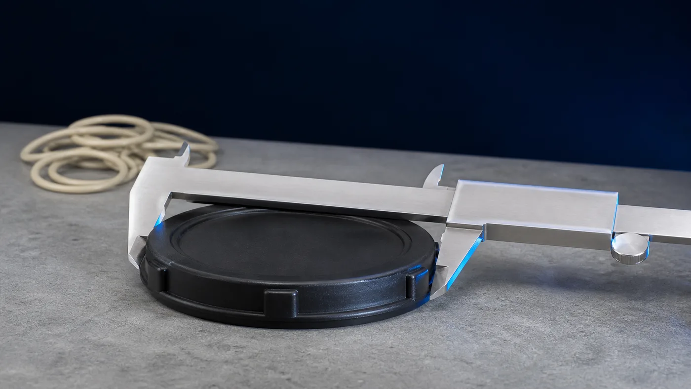 A moulded pool part being measured with a caliper on a granite surface plate